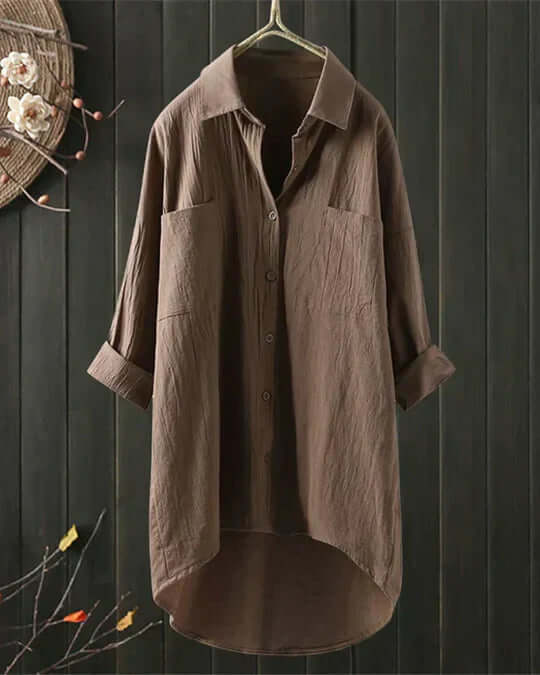 Casual button-up women's blouse featuring double pockets, collared neckline, and roll tab sleeves.