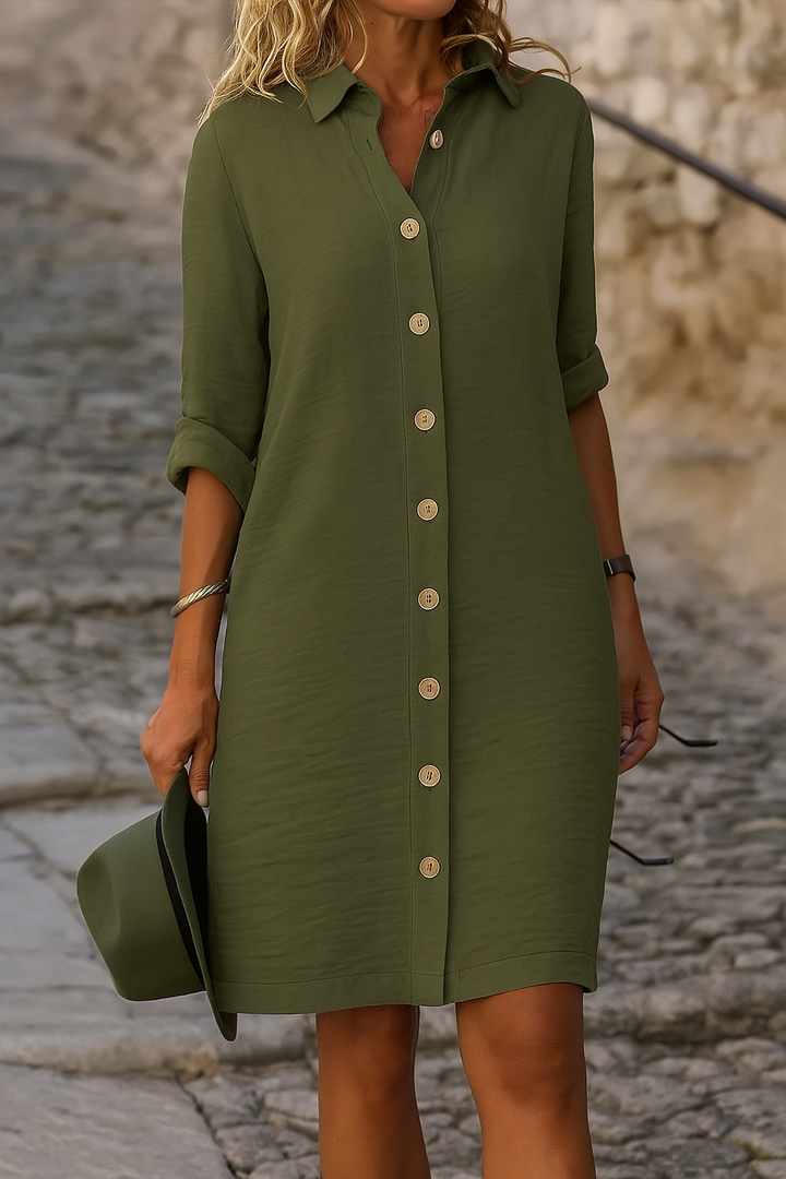 Women's versatile day dress with button front and adjustable roll-tab sleeves.