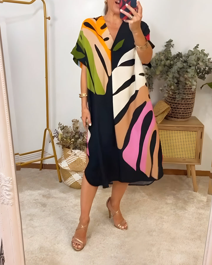 Stylish women's V-neck shift dress with vibrant abstract pattern, short sleeves, perfect for casual wear.