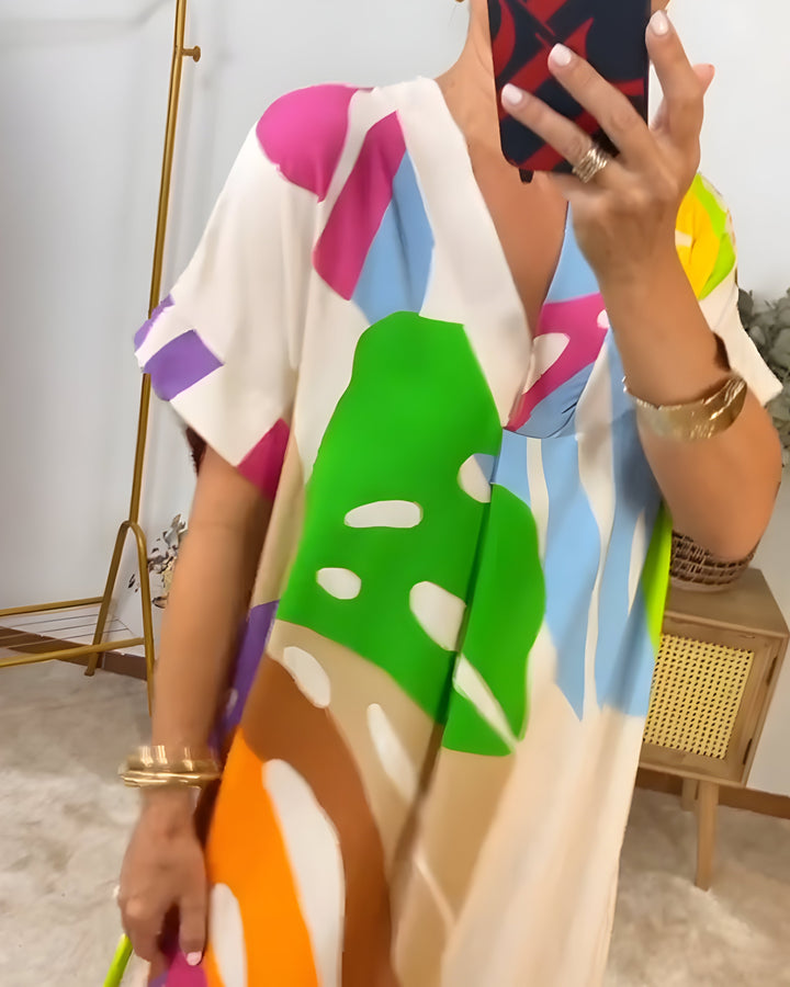 Colorful V-neck women's shift dress, abstract pattern, short sleeve, perfect for relaxed summer days.