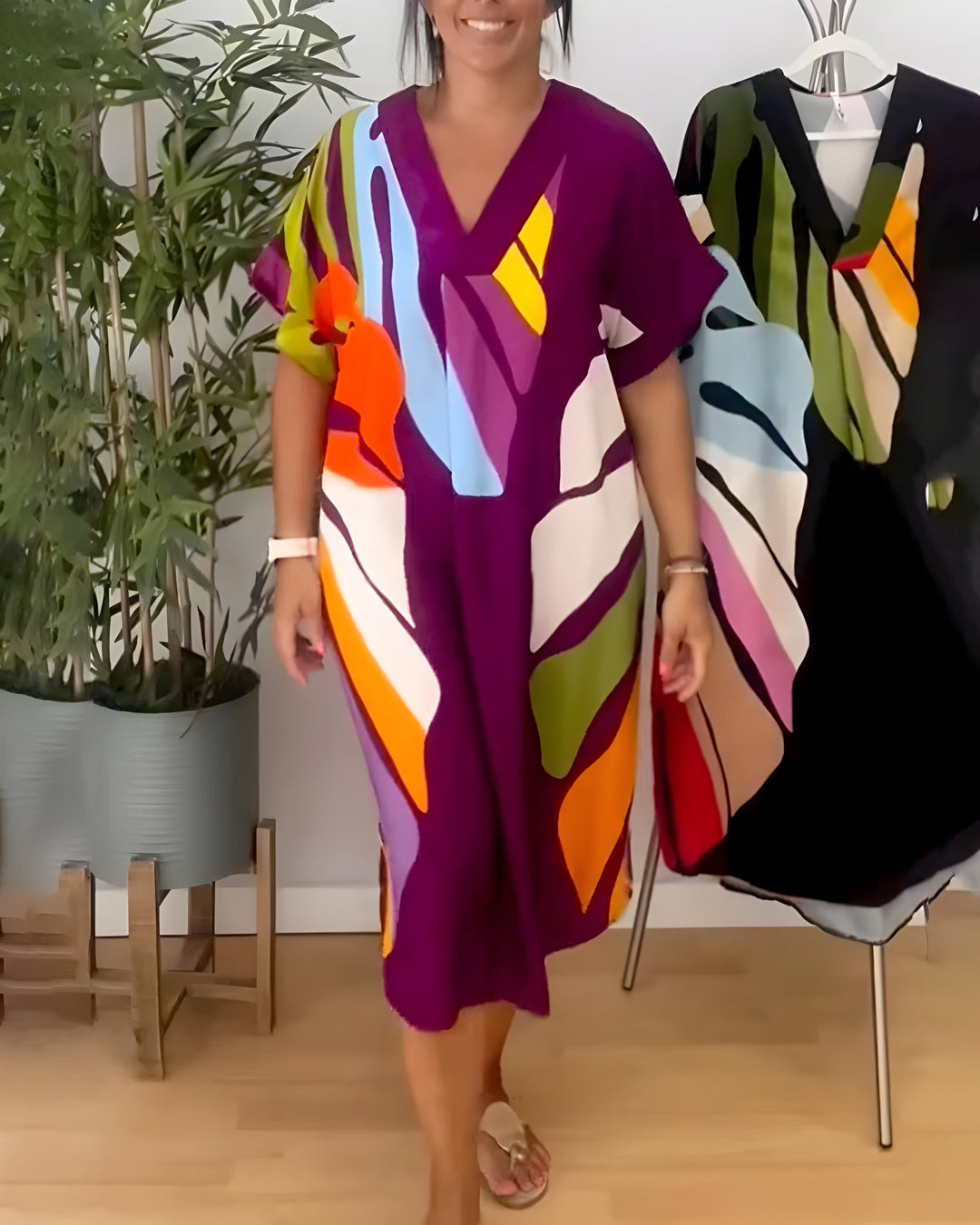 Elegant yet casual women's V-neck shift dress, featuring a bold abstract print and short sleeves.