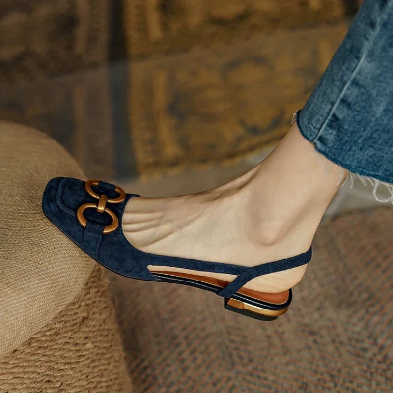Women's slingback flats in black with subtle chain accent, offering all-day comfort footwear.