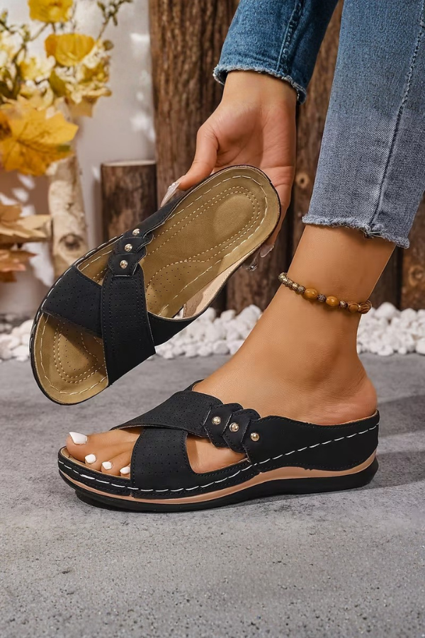Stylish women's perforated wedge slip-on sandals, perfect for summer vacations & everyday comfort. Easy to wear.