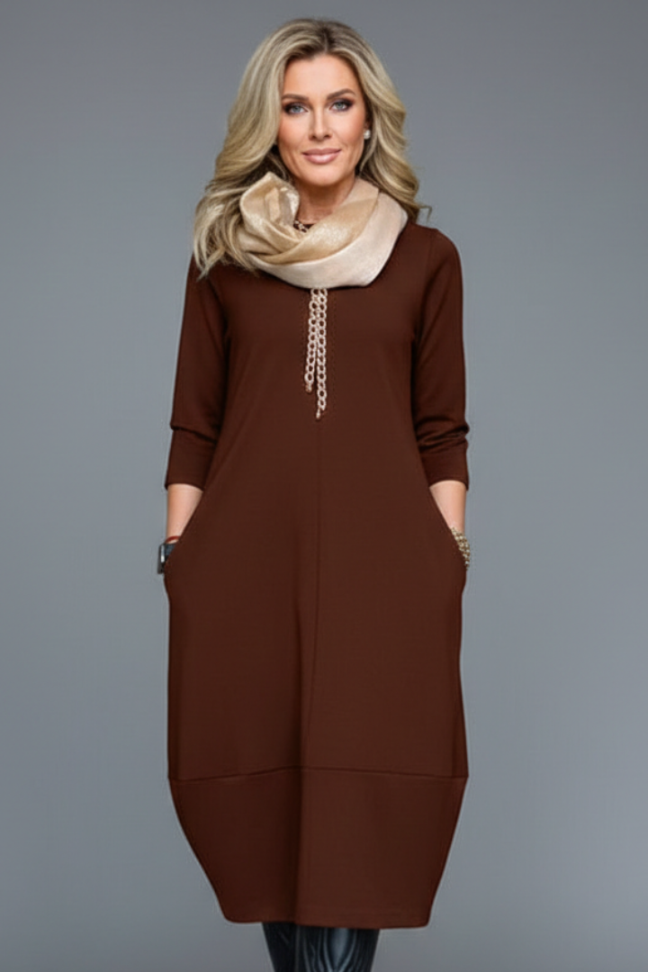 Soft A-line midi dress for women featuring 3/4 sleeves & handy pockets; ideal comfortable everyday wear.