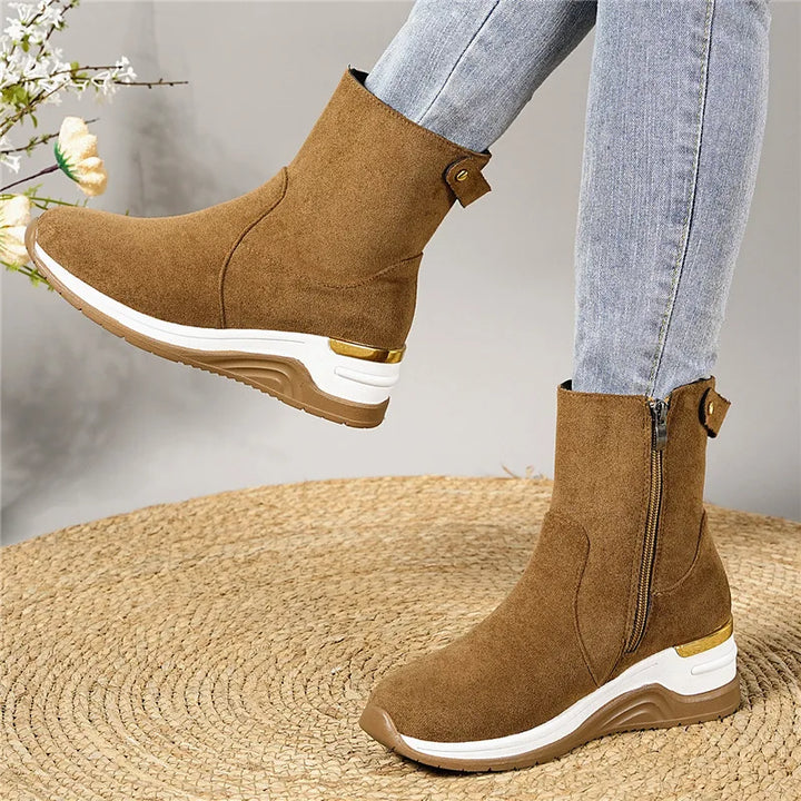 Brown suede ankle boots for women, emphasizing their soft texture and orthopedic design.