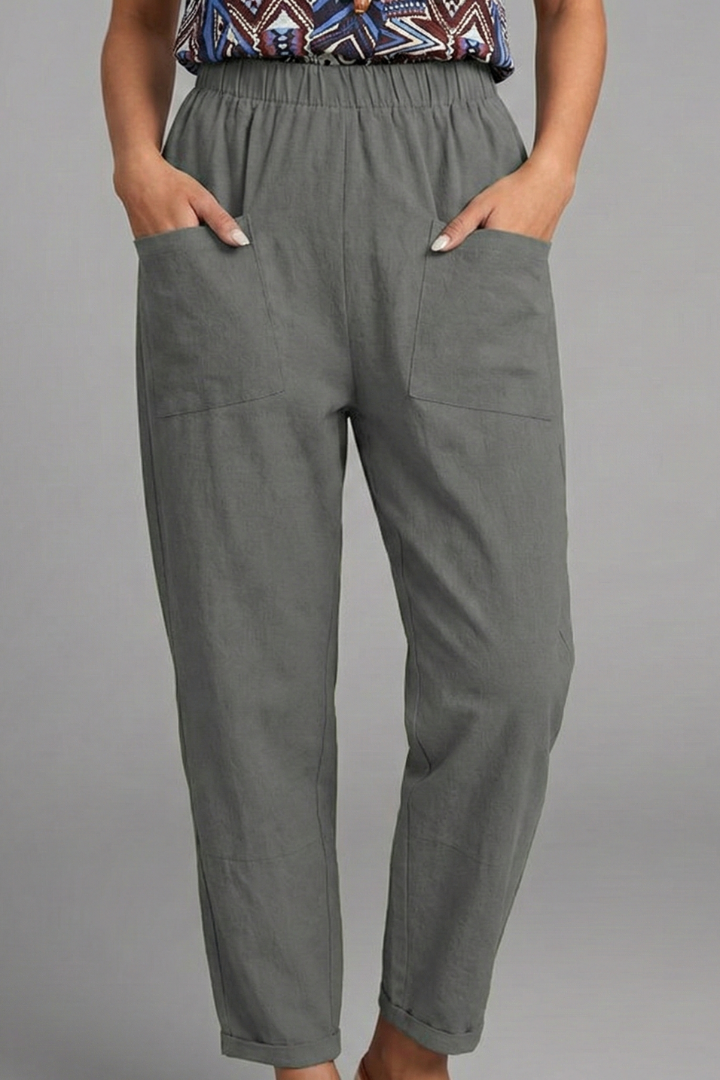 Soft women's tapered ankle trousers with a secure elastic waist and essential side pockets.