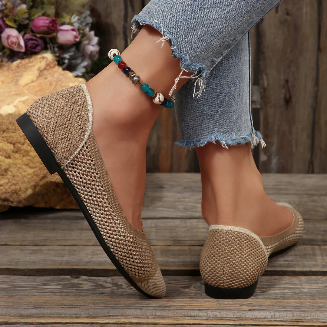 Top-down view of comfortable white knit pointed toe flats, highlighting the breathable mesh.