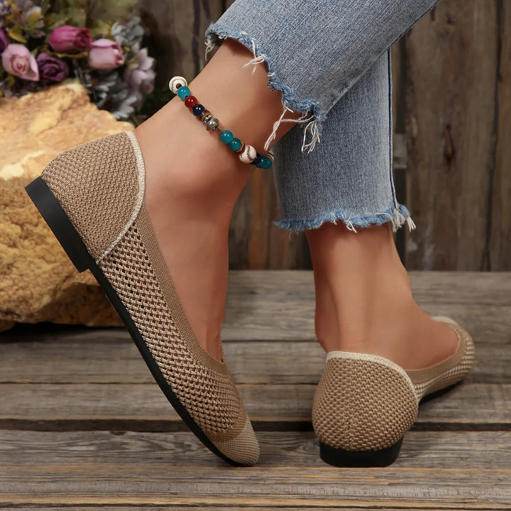 Top-down view of comfortable white knit pointed toe flats, highlighting the breathable mesh.
