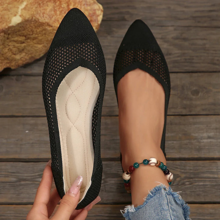 Group of women's comfortable knit pointed toe flats in various colors, showcasing the full range.