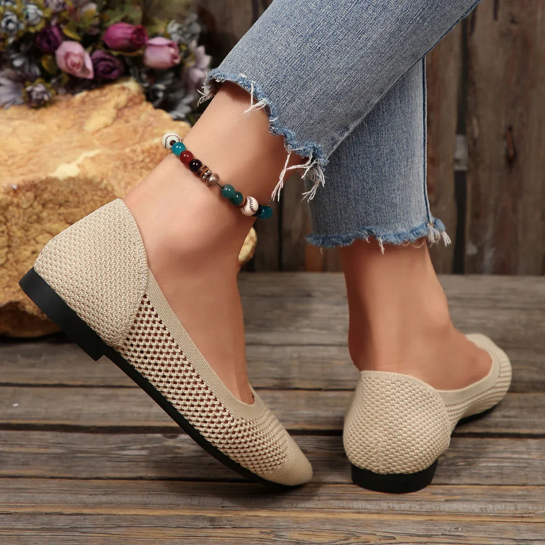 Back view of women's stylish black knit pointed toe flats, showcasing the elegant silhouette.