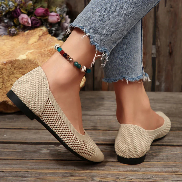 Back view of women's stylish black knit pointed toe flats, showcasing the elegant silhouette.