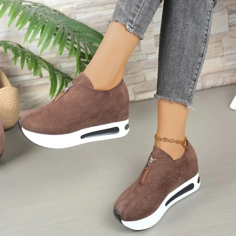 Pair of women's black platform shoes, featuring a sleek design and front zip for ease