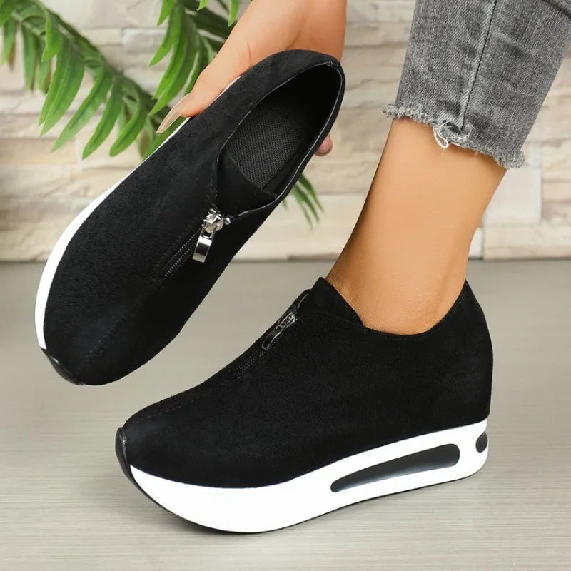 Studio shot of women's fashionable platform shoes with a unique front zip detail