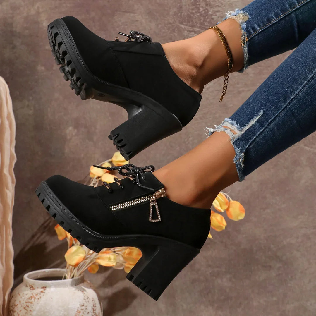 Model wearing women's black block heel lace-up boots, highlighting their fashion and everyday appeal.