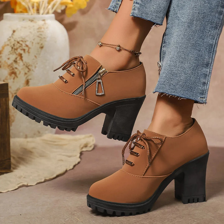 Stylish women's brown block heel ankle boots with a lace-up design, offering both fashion and orthopedic comfort.