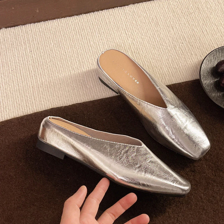 Effortless black women's flats, comfortable slip-on design in soft vegan leather for everyday wear.