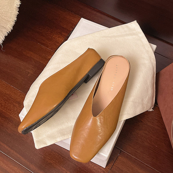 Black women's slip-on flats in soft vegan leather, offering effortless comfort and versatile style.