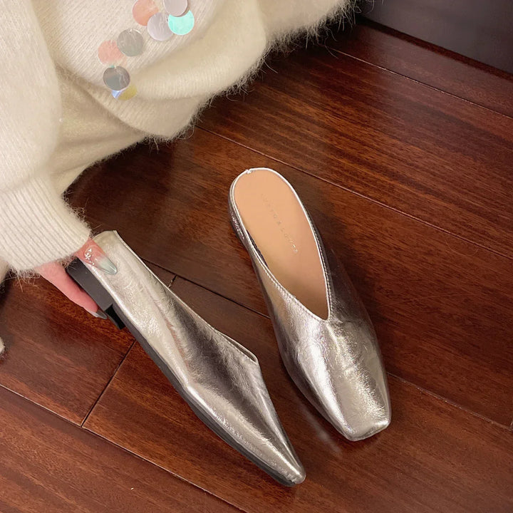 Stylish silver vegan leather women's flats, slip-on design for casual and everyday comfort.