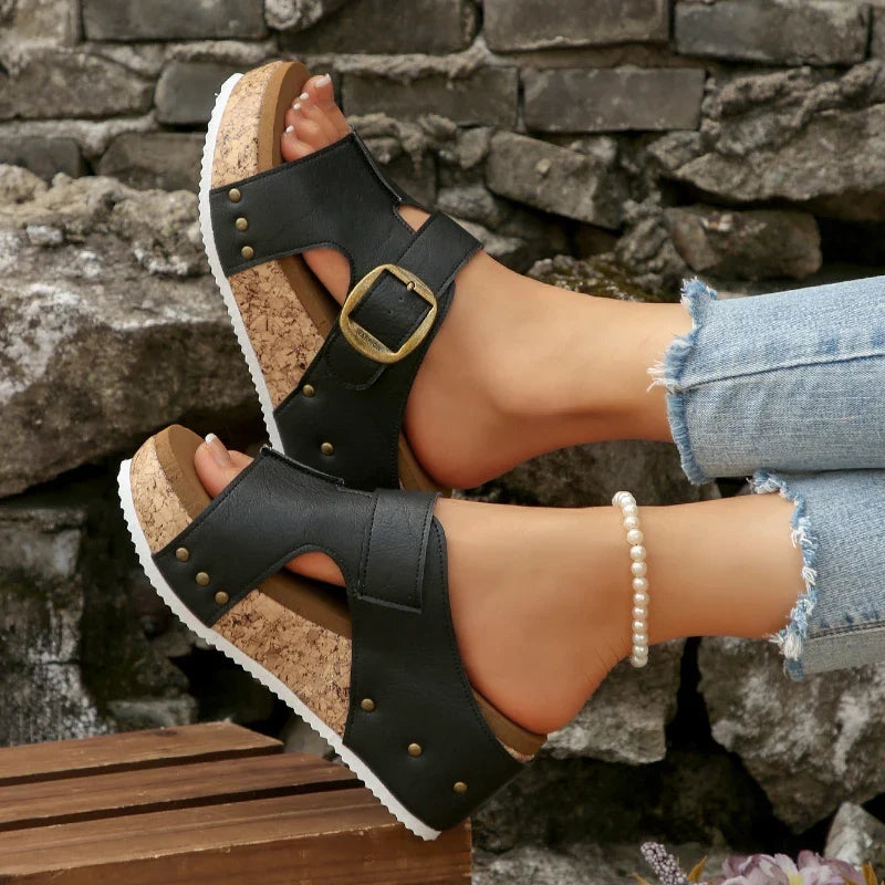 Close-up of a women's comfort slide sandal with a prominent buckle and orthopedic footbed