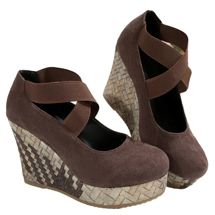 Detail of the comfortable sole and cross straps on women's wedge sandals; orthopedic summer footwear.