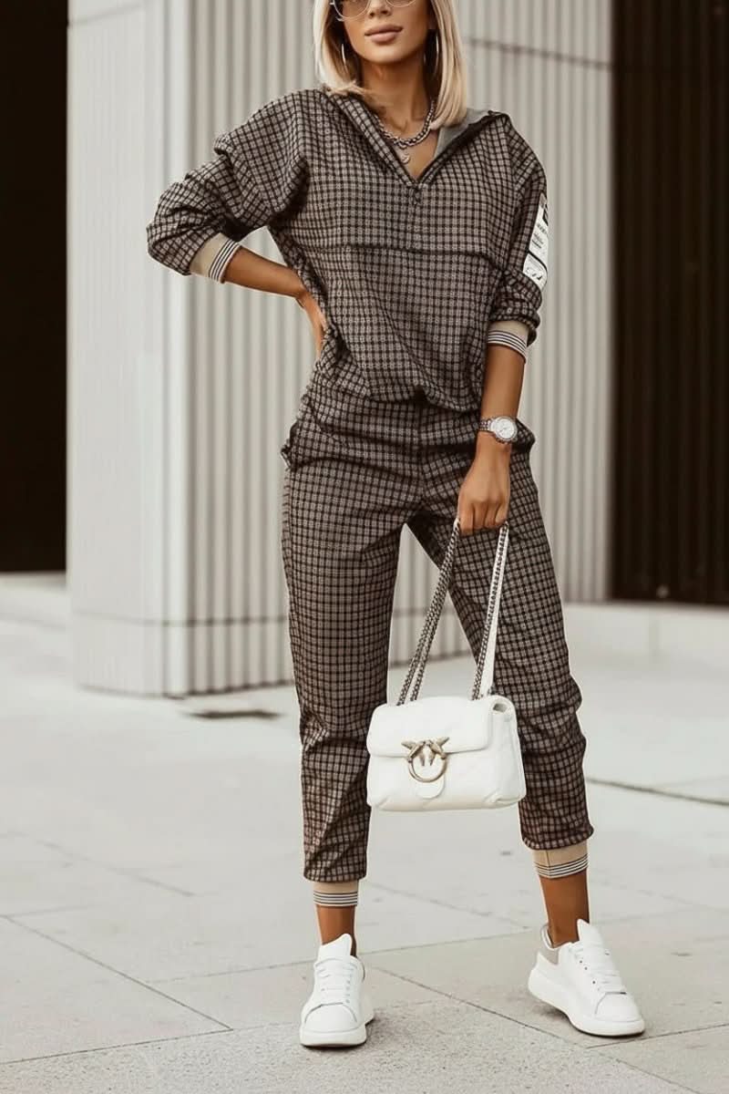 Matching women's tracksuit set featuring soft joggers & cozy sweatshirt for ultimate comfort.