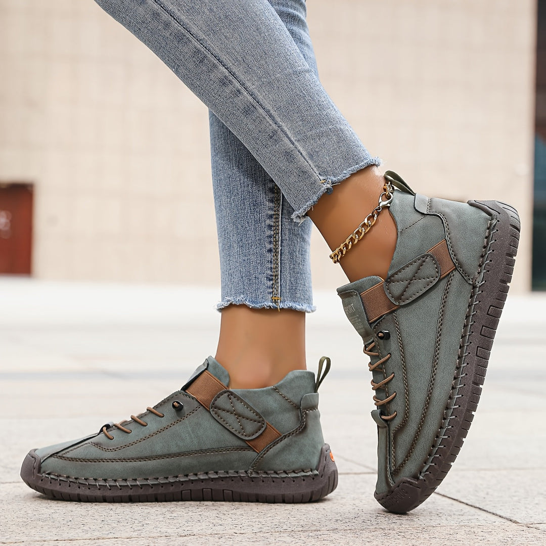 Women's comfortable flat lace-up sneakers, perfect for everyday casual wear. Features stylish stitch detail.