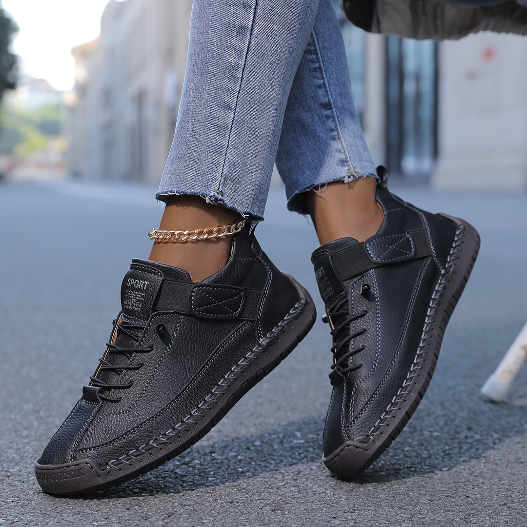 Top-down view of versatile women's fashion sneakers. Flat sole, secure lace-up closure & unique stitch detailing.