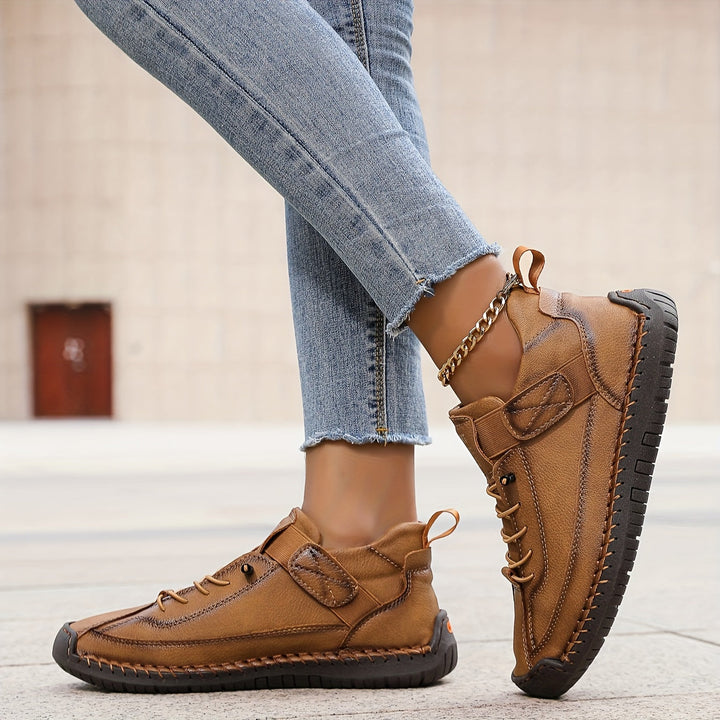 Close-up of unique stitch detail on comfortable women's flat lace-up sneakers, enhancing a casual style.