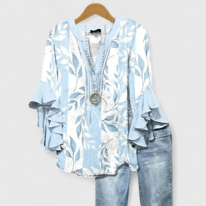 Elegant women's floral blouse featuring comfortable fabric & stylish ruffle sleeves.