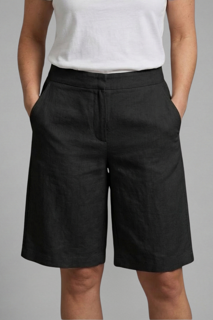 Comfortable women's knee-length shorts, mid-rise, elastic waist with drawstring, & functional side pockets.