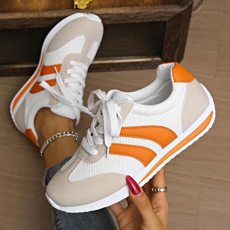 Stylish women's low-top lace-up sneakers in orange and purple, perfect for casual comfort.