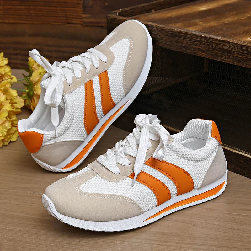 Athletic orange and purple women's low-top lace-up sneakers, designed for ultimate comfort.
