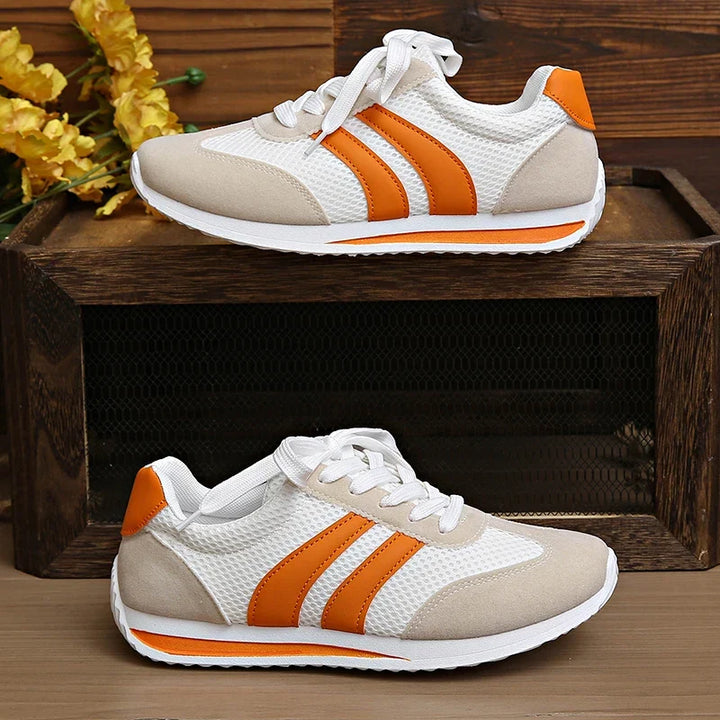 Vibrant orange and purple women's comfortable low-top lace-up sneakers for casual outfits.
