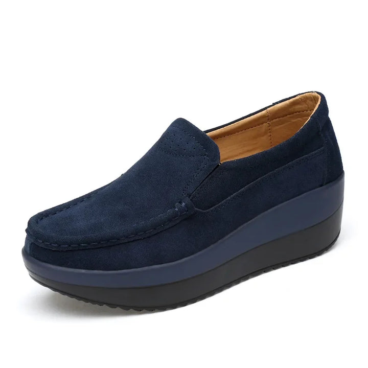 Close-up of women's suede slip-on loafers showing texture and comfortable design, casual flats