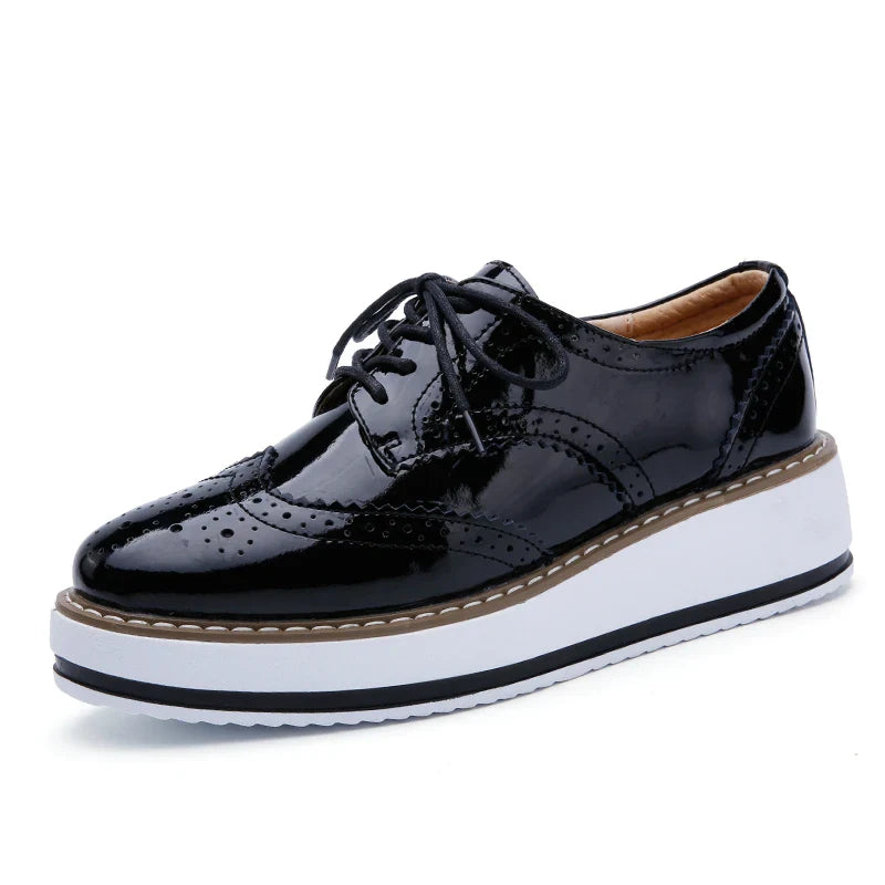 Back angle of women's perforated platform oxfords, emphasizing the sturdy platform and heel design.