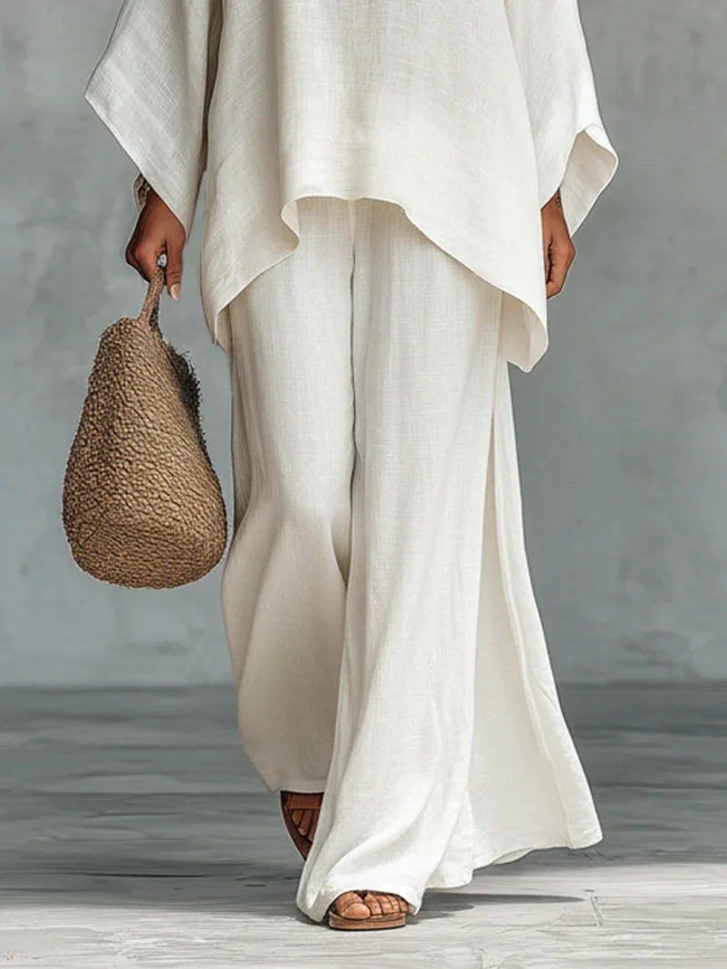 Elegant women's linen two-piece set with a relaxed top and wide-leg pants, perfect for casual summer wear.