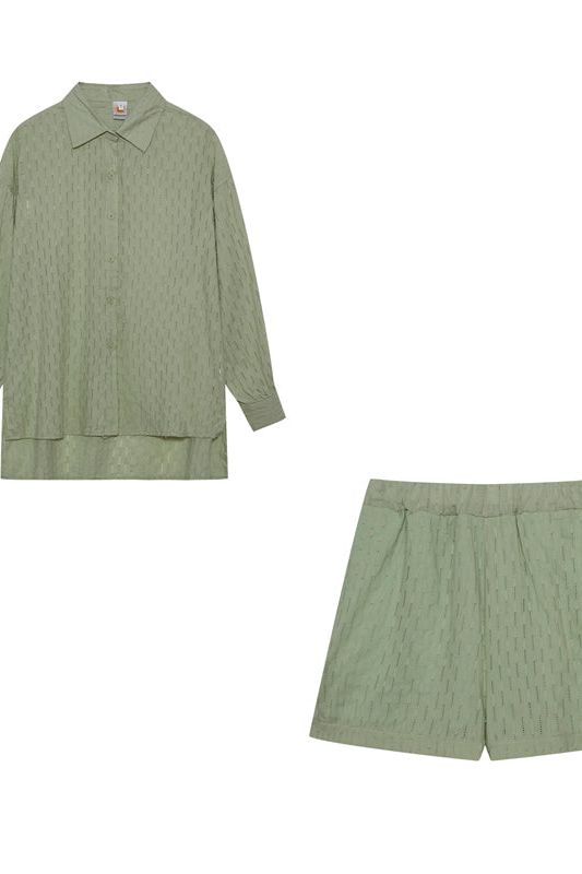 Trendy women's two-piece shirt & shorts outfit, ideal for spring fashion & summer comfort.