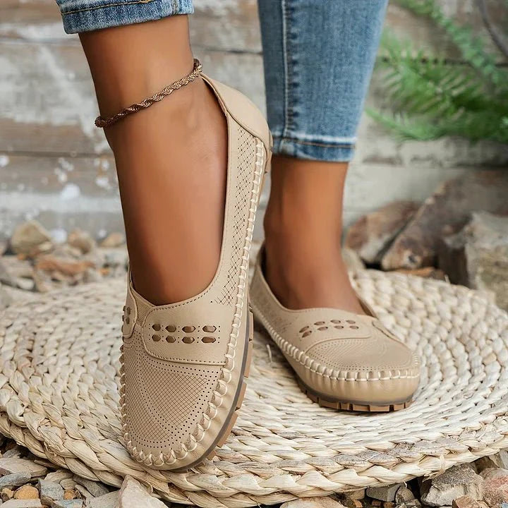 Stylish women's orthopedic loafers with breathable perforated design and flat sole for comfort.