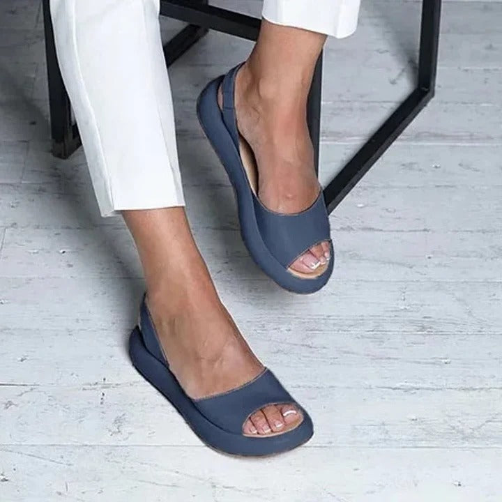 Comfortable women's easy-wear slip-on sandals with open toe & elastic band for warm weather.