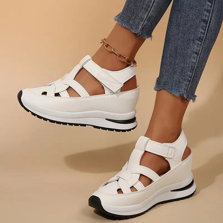 White women's sporty platform sandals with cutout design, adjustable strap, and open toe for summer comfort.