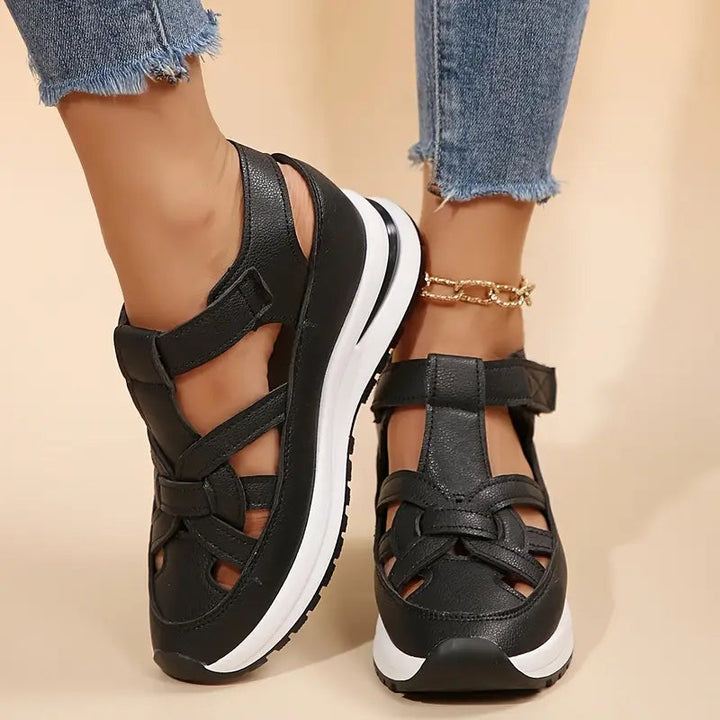 Black women's sporty platform sandals, open toe, cutout design, ideal for casual everyday comfort.