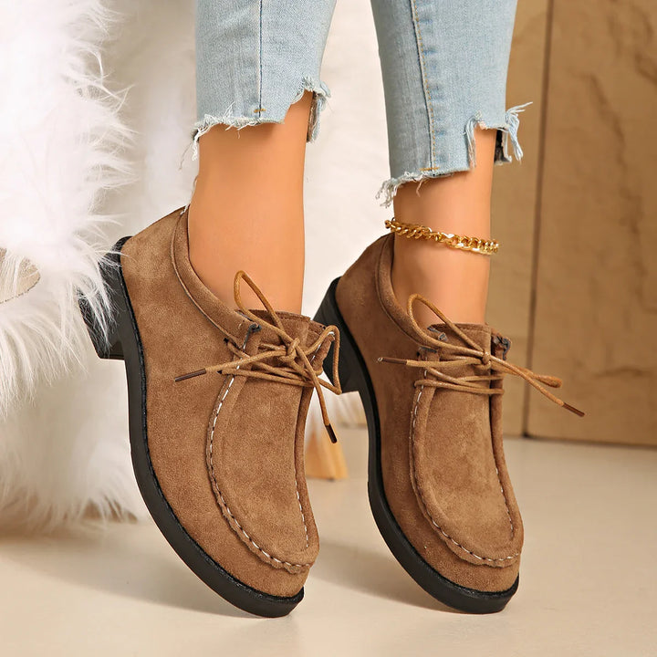 Pair of women's suede-like loafers displayed on a white background, showcasing their versatile style