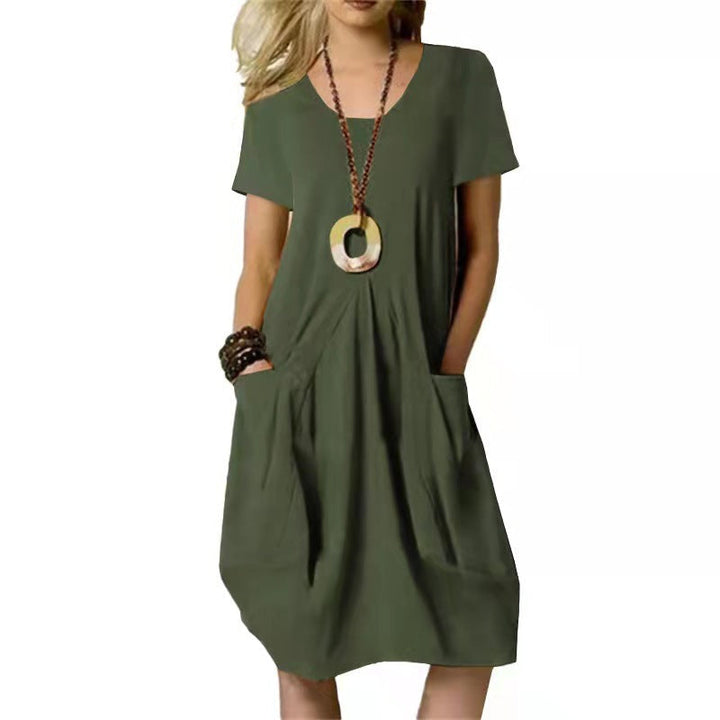 Versatile knee-length summer swing dress for women, featuring practical pockets & comfy short sleeves.