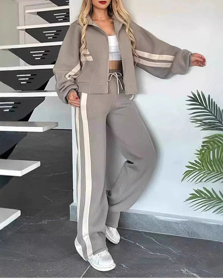 Women's comfortable wide leg tracksuit pants with subtle contrast side stripes. Great for relaxing.