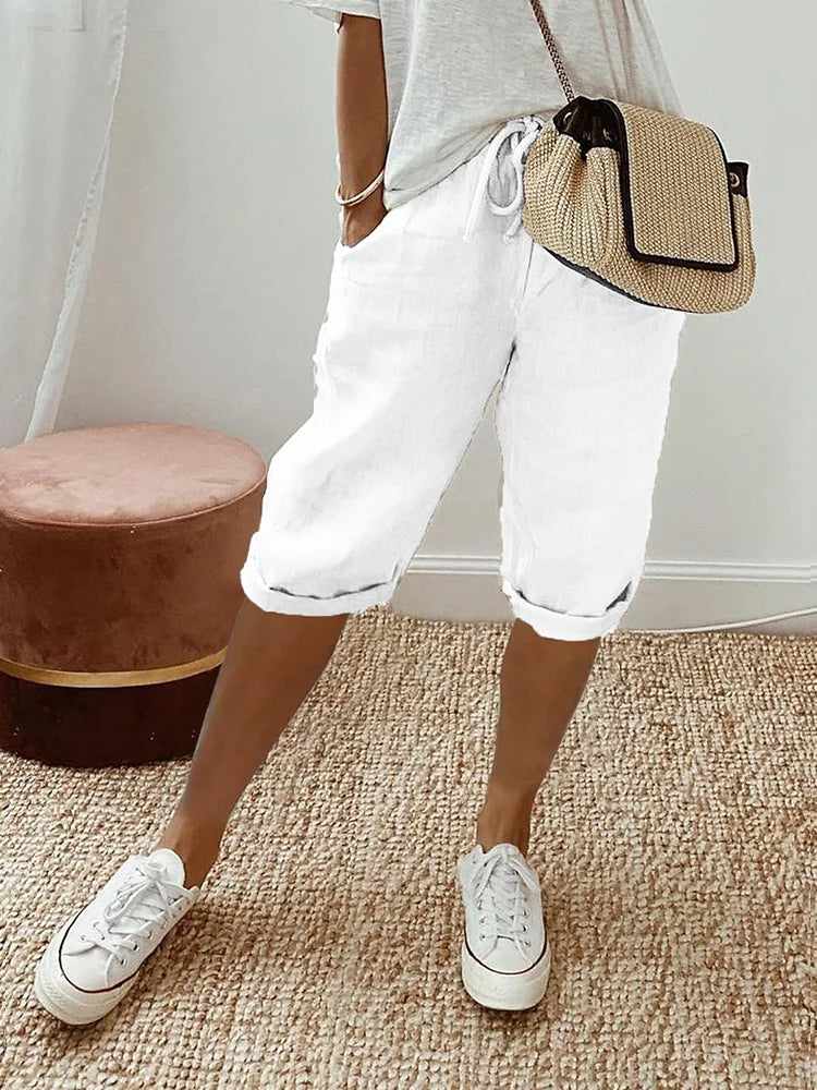Soft cotton women's capri pants with drawstring waist, roll hem, & practical pockets. Relaxed summer wear.