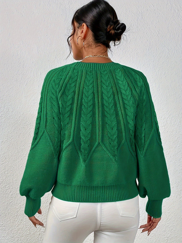 Women's winter wear cable knit sweater, relaxed fit, chunky knit for extra warmth.