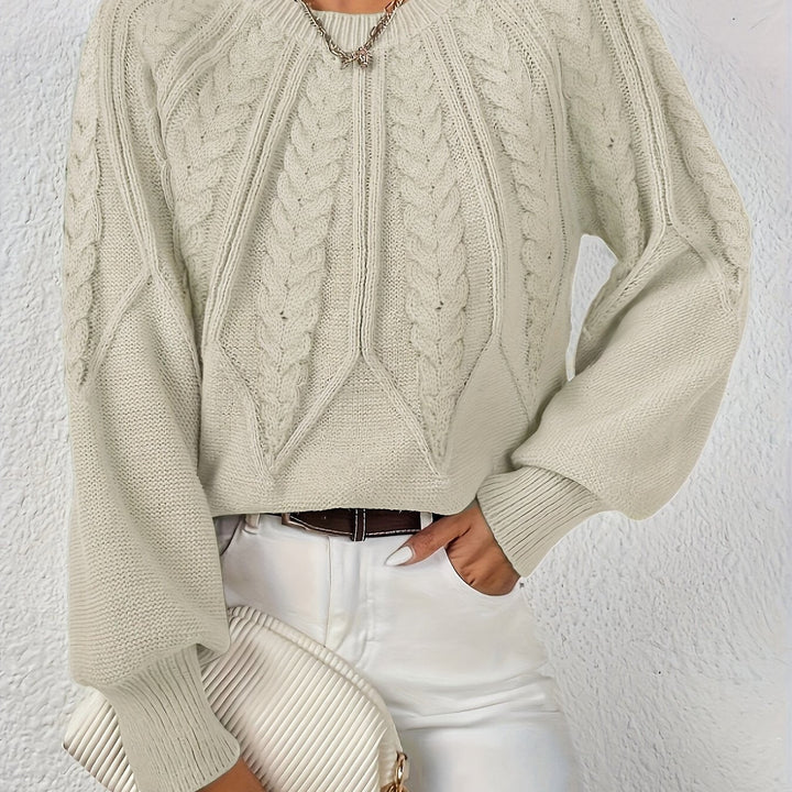 Women's stylish cable knit sweater, relaxed fit, perfect for a sophisticated fall outfit.