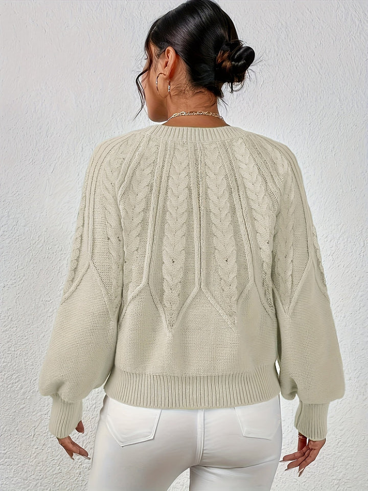 Warm women's lantern sleeve cable knit sweater, relaxed fit, a winter fashion staple.