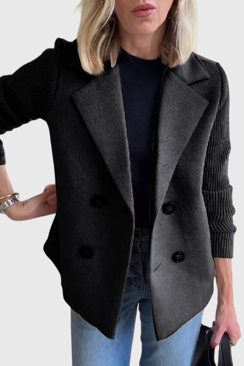 Close-up of a women's cozy knit blazer, showing the double-breasted buttons and soft fabric detail.