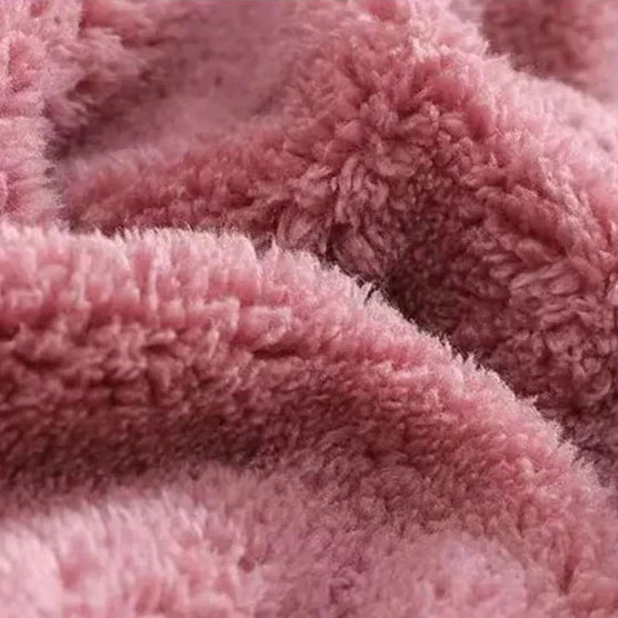 Lifestyle shot of a woman enjoying winter weather in a stylish and warm hooded zip-up jacket.